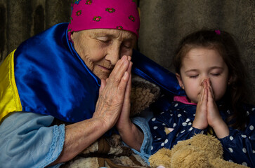 A woman and a child are hiding in a bomb shelter. War in Ukraine. Ukrainian children. Peace...