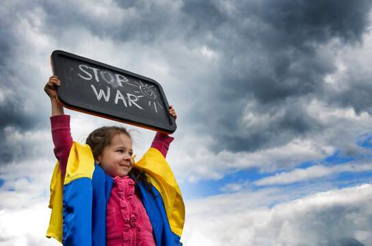 No war against the sky. Child with a slogan against war. Ukrainian child with the slogan stop war. War in Ukraine. Russian aggression against the country. Peace concept.
