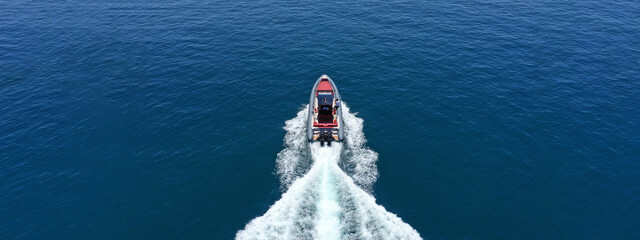 Aerial drone ultra wide photo of luxury rigid inflatable speed boat cruising in high speed in...
