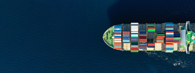 Aerial drone top down ultra wide photo of colourful truck size container tanker ship cruising deep...