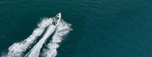 Aerial drone ultra wide photo of luxury rigid inflatable speed boat cruising in high speed in...