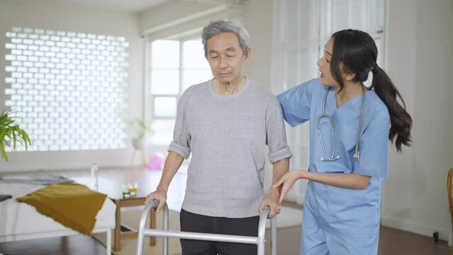 Caretaker Helping Elderly Woman With Walking Physical Therapy