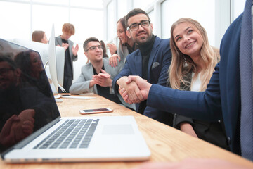 handshake of colleagues at a work meeting