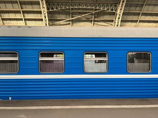 Blue train on the station, trains windows 