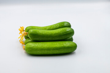 Select focused cucumbers on an isolated white background Cucumbers top view, food background. Macro Photo food cucumbers. Texture pattern background green cucumbers. Image fresh green cucumbers.