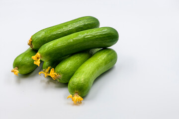 Select focused cucumbers on an isolated white background Cucumbers top view, food background. Macro Photo food cucumbers. Texture pattern background green cucumbers. Image fresh green cucumbers.