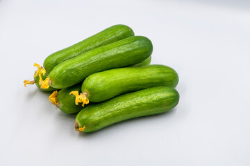Select focused cucumbers on an isolated white background Cucumbers top view, food background. Macro Photo food cucumbers. Texture pattern background green cucumbers. Image fresh green cucumbers.