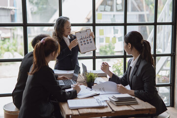 Group of Asian business people meeting about business plan and presentation at office.