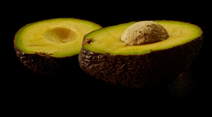 avocado fruit lies on a black background