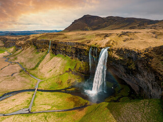 Aerial view of the Seljalandsfoss - located in the South Region in Iceland right by Route 1. Visitors can walk behind it into a small cave. Most popular waterfall in Iceland.