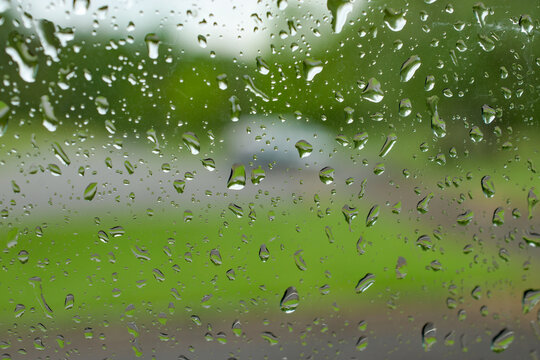 Rain on Car Window.  Sitting in my car waiting for the thunderstorm to pass so I can get out without getting soaking wet.
