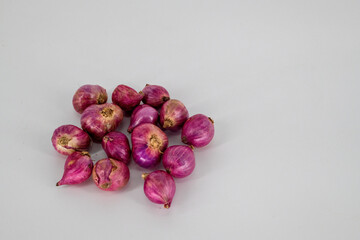 Selective focused Small Red onions isolated on white background. small mild-flavored onion-like clustered bulbs used for seasoning isolated on white background..