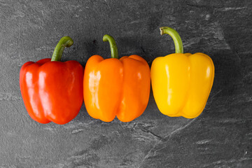 Three pepper on dark background, vegetables for the restaurant, vegetables on a white background
