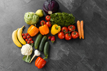 Fresh vegetables and fruits on a black background. Organic food. Top view. Free copy space.