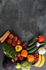 Fresh vegetables and fruits on a black background. Organic food. Top view. Free copy space.