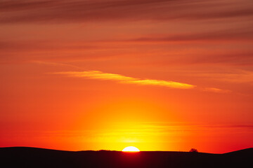 Sun and hill at sunset.