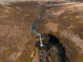 Aerial view of the Svartifoss waterfall surrounded by basalt columns in the south of Iceland....