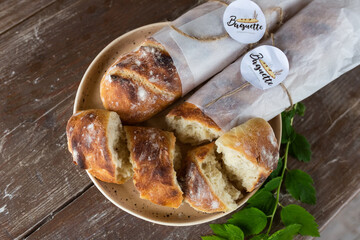 Fresh homemade baguette bread on wooden table. Healthy vegan eco food concept	