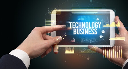 Close-up of hands holding tablet with business inscription