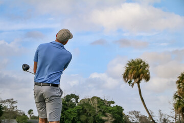 golfer looking after his tee shot