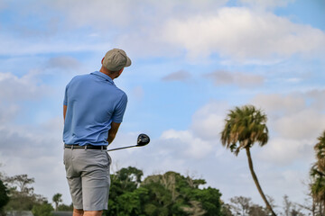 a golfer looking after his tee shot