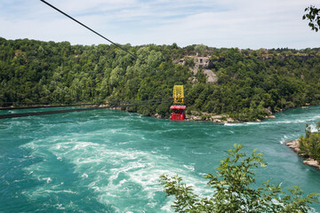 Niagara Falls Whirlpool Rapids Aero Trolley Car over whirlpool of gushing waters of Niagara River,...