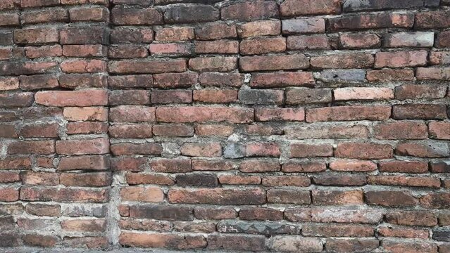 Dingy old threadbare brick wall. Camera slowly moving from left to right.
