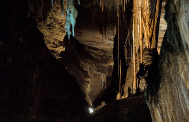 Deep cave opening showing lots of formations like stalactites, stalagmites and columns some thousands of years old and extremely delicate.