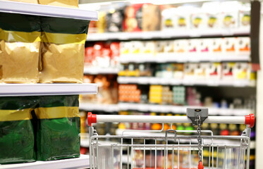choosing a dairy products at supermarket.empty grocery cart in an empty supermarket