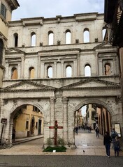 Verona, Italy. The ancient Porta Borsari (Roman gate) 1st century A.D. Verona (UNESCO world heritage site). View from Corso Cavour. Selective focus. Vertical