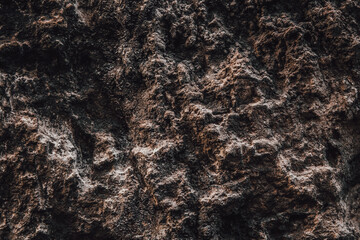 Brown wall texture. Stone background. Rock texture. Grunge Rough structure. Abstract texture. Rock surface with cracks. Rock pile. Paint spots.