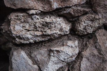 Brick brown. Rock pile. Rock background. Rock texture. Stone background. Paint spots. Rock surface with cracks. Grunge Rough structure. Abstract texture.