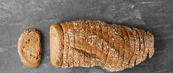 Sliced whole grain bread with oat flakes. Wholemeal bread.