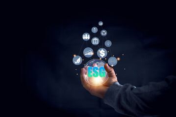 Environmental social governance(ESG) business strategy investing concept. Hand holding virtual globe with ESG icon. Using alternative energy Technologies and Renewable Resources to Reduce Pollution.