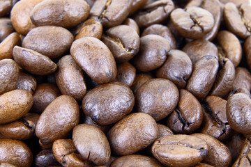 Roasted coffee beans background. Heap of roasted coffee beans