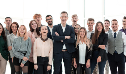 happy group of young employees with hands up