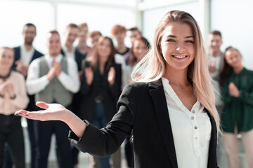 successful business woman on the background of a group of young employees.