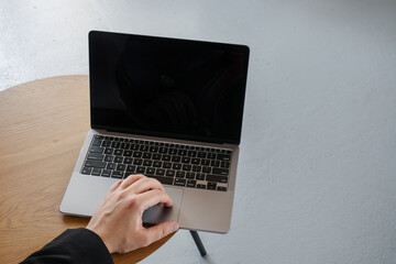 Hands on macbook in loft studio. Programmer concept. The concept of a man at the computer. A place for your layout.