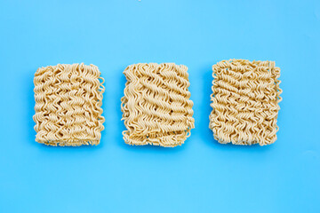 Dried instant noodles on blue background.