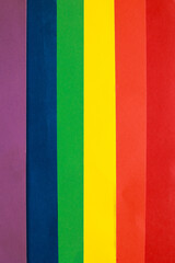 Rainbow LGBTQ or gay pride flag on colo paper texture. Abstract background for design.