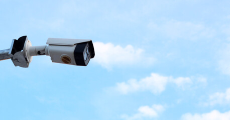 Security CCTV camera on a pole. Blur blue sky