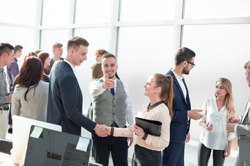 group of diverse employees discussing standing in the office