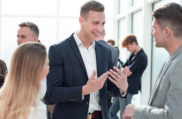 employees discussing their ideas standing in the office corridor