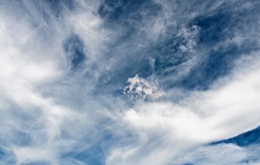 Swirls of cirrus clouds in the blue sky