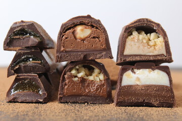 background of candy candy chocolate. sweets in section with fillings of praline ganache with peanuts whole crushed close-up. A day without diet sweet day chocolate