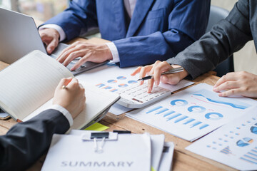 Close up businessman hand using calculator and working with laptop calculate about finance accounting at coffeeshop outdor.finance accounting concept