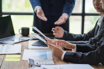 Close up businessman hand using calculator and working with laptop calculate about finance accounting at coffeeshop outdor.finance accounting concept