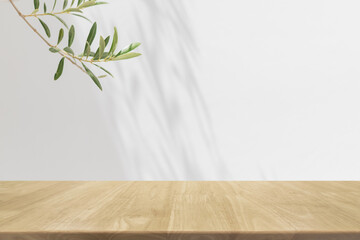 Empty wood table top and blurred white wall in garden background with Green leaves - can used for...
