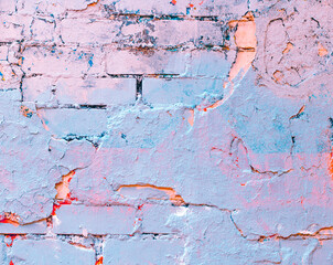 Brick wall. Paint spots. Abstract purple background. Holographic neon colors. Rock texture. Stone background. Rock holography. Multicolored Painted Wall. Wall abstraction. Pink stone