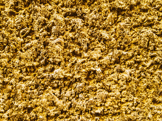 Golden Ore rocks. Stone background. Abstract texture. Rock pile. Gold texture. Stone texture. Structure. Shimmering surface. Precious Foil. Rough structure mineral. Rock texture.